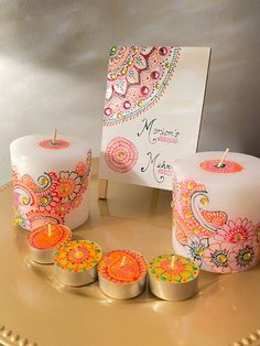 three candles are sitting on a table next to a card