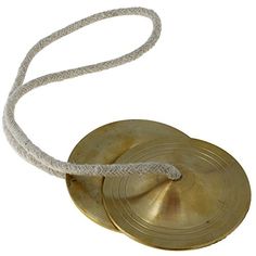 an old brass bell with a white rope attached to it's end, on a white background