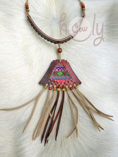 Unleash your bohemian soul with this beautiful one off unique handmade leather necklace. It is made from the finest quality brown leather. The brown leather section of the necklace has vintage hand embroidered Hmong tribal fabric incorporated into it's design. This is not only a necklace it is a piece of art. This long fringe leather choker necklace is adjustable at the back so it fits all sizes. Available in a wide range of colors. Please contact me if you would prefer a different color combina Hand-stitched Adjustable Bohemian Jewelry, Traditional Leather Jewelry For Festival, Artisan Hand-stitched Festival Jewelry, Traditional Handmade Leather Jewelry, Bohemian Leather Necklace For Festivals, Artisan Brown Leather Necklace, Handmade Leather Necklaces For Festivals, Hand Tooled Leather Bohemian Jewelry, Handmade Leather Festival Necklaces