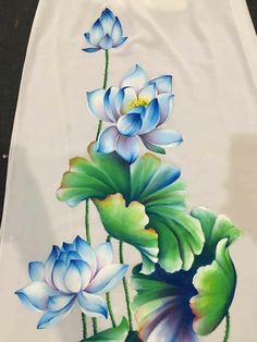 a painting of water lilies and leaves on a white cloth with blue flowers in the center