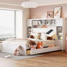 a bedroom with a bed, bookcases and stuffed animals