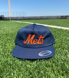 "Grab yourself our fully embroidered vintage style New York Mets unstructured 5 panel hats! This hat is the perfect gift for any Mets fan! This hat features a Lightly-structured, mid-profile. 3¼\" crown, five-panel. Flat bill. Snapback closure. Hat Specs: - Yupoong - 60/40 cotton/polyester blend - Lightly-structured, five-panel, mid-profile - Flat bill - Snapback closure" Retro 5-panel Hat For Sports Events, Retro Baseball Season Hat With Embroidered Logo, Vintage Snapback Hat With Embroidered Logo For Baseball Season, Retro Hat With Embroidered Logo For Baseball Season, Retro Dad Hat With Embroidered Logo Snapback, Retro Snapback Hat For Fan Gear, Retro Snapback Hat For Fans, Retro Adjustable Snapback Hat For Fan Gear, Adjustable Retro Snapback Hat For Fan Gear