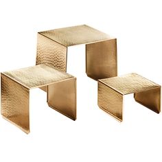 three gold colored metal tables sitting next to each other