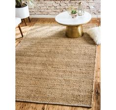 the rug is made from natural jute and has a gold base