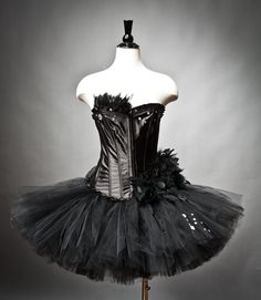 a mannequin is dressed in black and white tutu skirt with flowers on the bottom