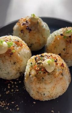 some food is on a black plate with sprinkles and seasoning around it