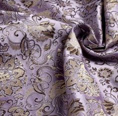 a purple and gold paisley print fabric