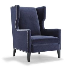 an upholstered blue chair with white piping on the armrests and back