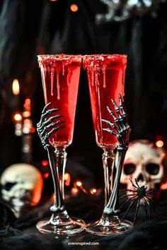 two wine glasses with red liquid and spooky decorations