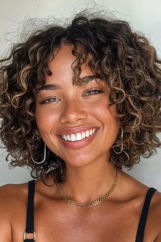 This is definitely one of the more fashion-forward options on this list, but it’s still shockingly easy to maintain! Add some charming curls to your medium-length bob. Click here to check out more low-maintenance medium-length haircuts for on-the-go women. 3b Bob Curly Hair, Short Hairstyle Women Low Maintenance, Short Curly Haircuts For Oval Faces, Short Round Curly Haircut, Curly Hair Bob Naturally, Short Curly Hair Color Ideas, Short Curly Cuts Natural Curls, Bob Cut Curly Hair, Round Curly Cut