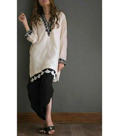 ✨KURTA White kurta with scallop hem line, black thread embroidery around neck and sleeves. ✨BOTTOM It has black dhoti pant ✨DUPPATA Black chiffon dupatta with scallop on all four sides. ✨This super trendy dress is perfect for party, semi casual look or festival. ✨We do not deal with replica. These are all custom made dress as per our customers choice and measurements. ✨If you want any changes in the outfit people contact us we will guide you as per your preference. ✨We assure you that we use onl Kurti Sets, Nikkah Dress, Pakistani Fashion Casual, Casual Indian Fashion, Pakistani Fancy Dresses, Semi Casual, Pakistani Dresses Casual, Salwar Kamiz, Kurta Designs Women