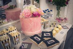 a table topped with lots of cakes and cupcakes