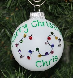 a white ornament with merry christmas lights on it