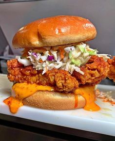 a chicken sandwich with coleslaw and slaw on it