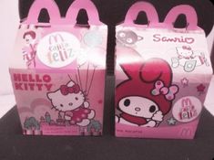 two hello kitty bags sitting on top of a table