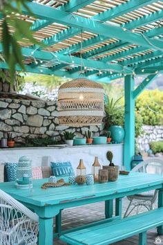 an outdoor dining area with blue and white furniture