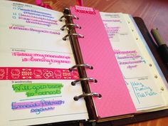 an open planner book sitting on top of a wooden table