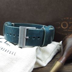 "At Cozy Handmade, we pride ourselves on using the highest quality materials for our products. This watch strap (NAT2) is made of premium full grain Italian veg tanned leather from one of the best tanneries in Italy. The leather features gorgeous texture and natural characteristics which will give your watch an instant rugged and vintage stylish look. Its appearance will get even better with time as it acquires patina, wrinkles and marks. The color of Military 106 is a combination of different s Blue Watches With Leather Strap For Everyday Use, Blue Watch With Adjustable Leather Strap, Blue Watch With Leather Strap And Adjustable Fit, Everyday Watch Band With Stainless Steel Clasp, Adjustable Blue Leather Watch Band, Blue Leather Strap Watch Band For Everyday Use, Blue Watch Accessories With Adjustable Leather Strap, Blue Adjustable Leather Strap For Watch, Handmade Blue Bracelets For Everyday