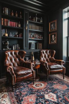 two leather chairs sitting in front of a book shelf