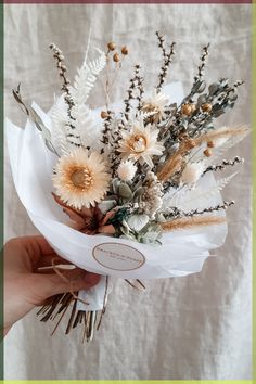 a person holding a bouquet of flowers in their hand