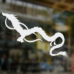 a white dragon sticker on the side of a window