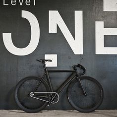 a bike leaning against a wall with the words level one on it's side