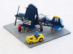 a lego model of an airplane with people around it