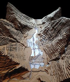 an intricate wooden sculpture is shown in the dark with its reflection on it's surface