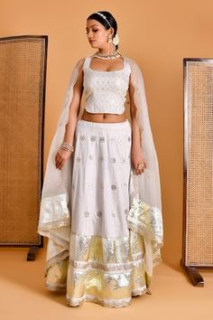 Smoke white lehenga with gota embellishment. Paired with sequin, thread embroidered padded blouse and scallop bordered dupatta. - Aza Fashions Designer White Choli With Mirror Work, Designer Wear White Choli With Mirror Work, White Chanderi Sharara For Reception, White Choli For Diwali Reception, White Chanderi Sets For Reception, Fitted White Traditional Wear With Mirror Work, White Chanderi Choli With Mirror Work, White Chanderi Lehenga For Reception, White Fitted Anarkali Set With Mirror Work