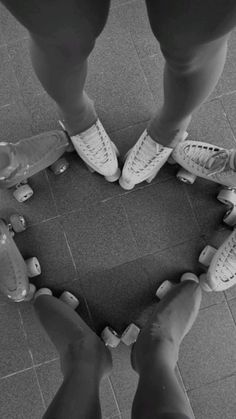 two people standing in the shape of a heart with their feet on skateboards and shoes