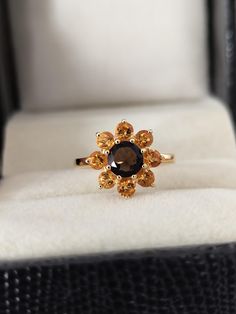 a ring with an orange and black stone in it