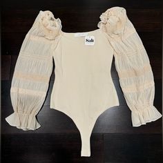 Brand New Chic Beige Bodysuit For Spring, Beige V-neck Bodysuit For Spring, Spring Beige V-neck Bodysuit, Beige Bodysuit For Spring Parties, Spring Beige Lined Bodysuit, Elegant Spring Bodysuit For Brunch, Spring Party Beige Bodysuit, Chic Spring Bodysuit For Brunch, Fitted Cream Bodysuit For Party