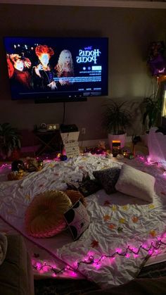 a living room filled with furniture and a flat screen tv mounted to the side of a wall