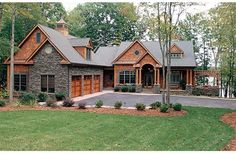 a large brick house with two garages on each side