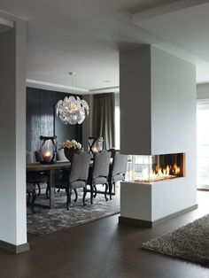 an elegant dining room with fireplace and chairs