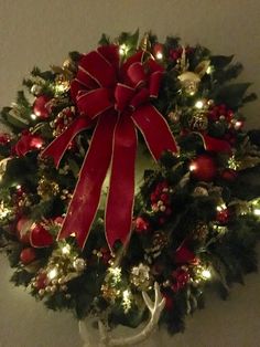 a christmas wreath with red bows and lights