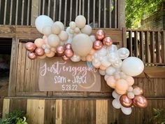 a sign that says just engaged with balloons