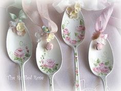 four spoons decorated with pink flowers and bows on them, one has a bow