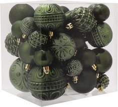 a bunch of green ornaments in a clear box