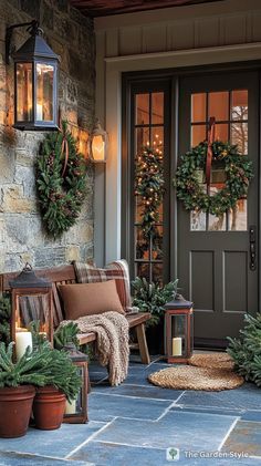 the front porch is decorated for christmas with wreaths and potted plants