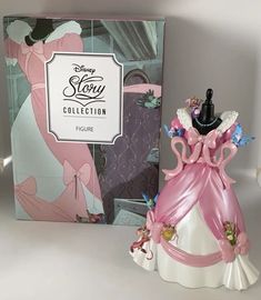 the figurine is next to the box for it's packaging on display