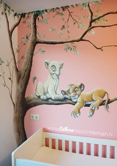 a baby's room with a lion mural on the wall