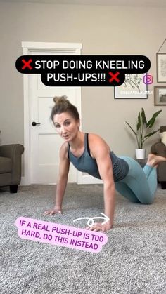 a woman is doing push ups on the floor with a pink sign in front of her