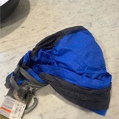 a blue bag sitting on top of a white counter next to a black and gray object