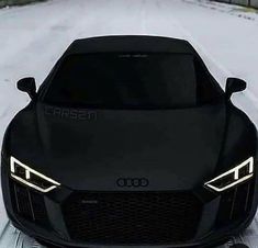 a black sports car parked in the snow