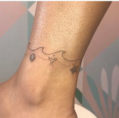 a woman's foot with a small tattoo on the side of her left ankle