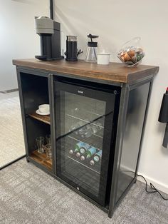 an empty wine cooler in the corner of a room