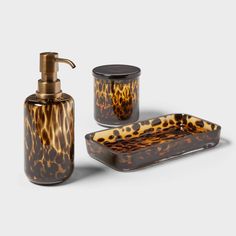 an animal print bathroom set with soap dispenser and dish