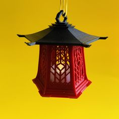 a red lantern hanging from a yellow background