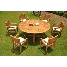 a wooden table and chairs in the grass